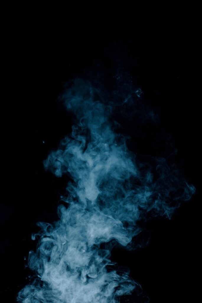 steam texture from a hot drink on a black background blue smoke with copy space