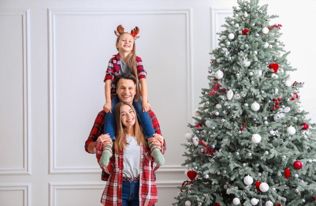 Happy,Family,Near,Beautiful,Christmas,Tree,At,Home