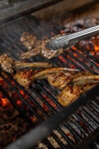 Several,Pieces,Of,Lamb,Rack,Lie,On,A,Metal,Grill