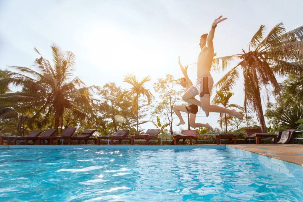 People,Jumping,To,The,Swimming,Pool,,Beach,Holidays,,Friends,Having