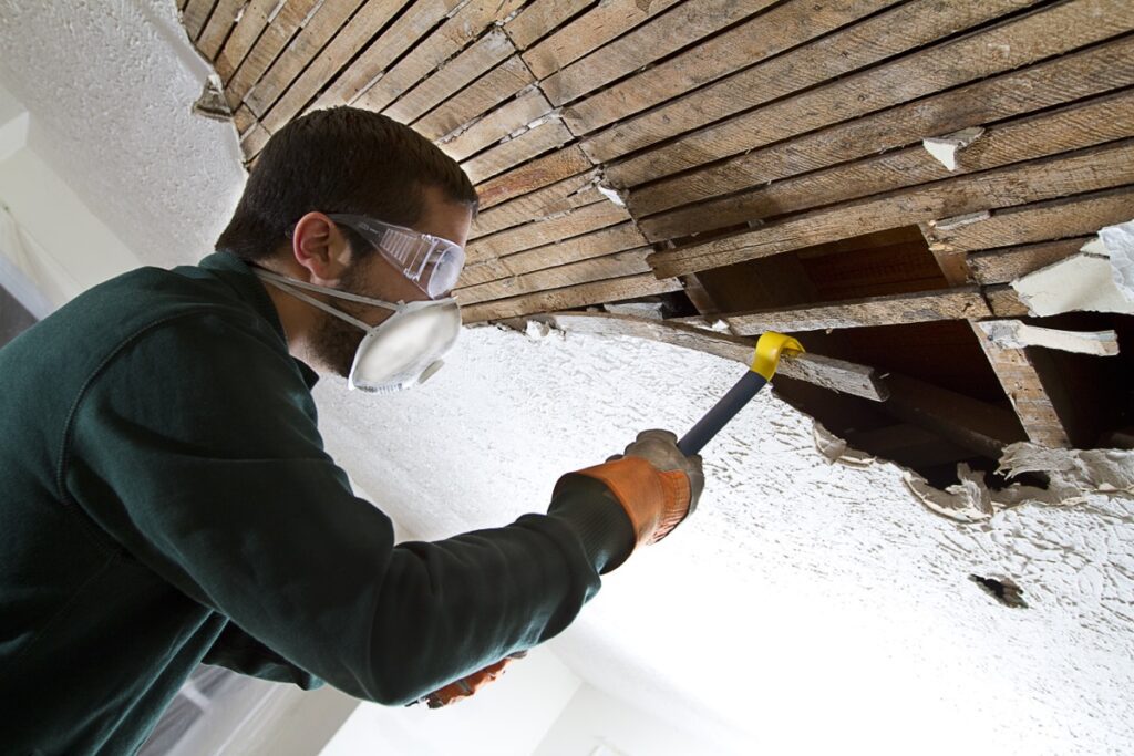 Ceiling,Demolition,Man,Removing,Plaster,Lathe,From,Ceiling,With,A