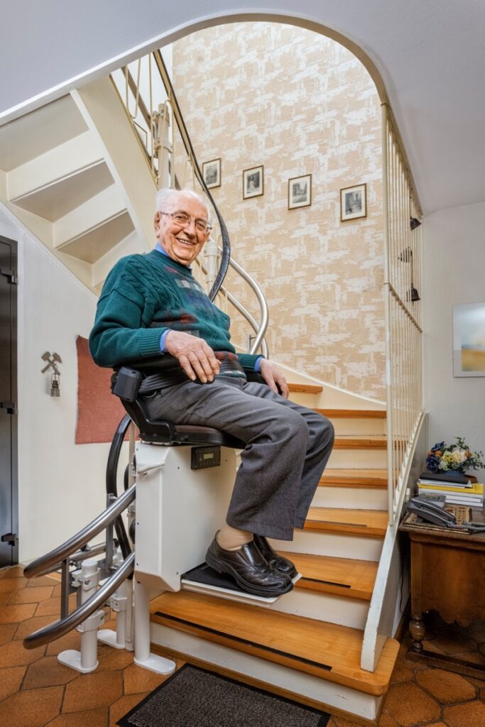 Elderly,Man,In,The,Staircase,Using,The,Stairlift