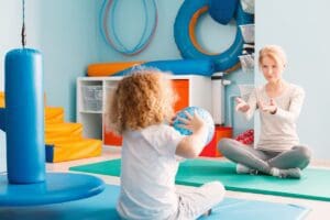 Boy,Playing,With,His,Therapist,Using,A,Ball