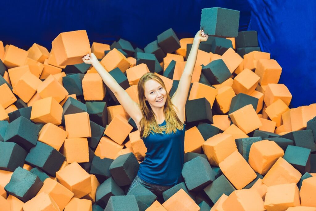 Young,Woman,Playing,With,Soft,Blocks,At,Indoor,Children,Playground