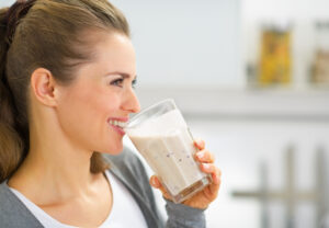 Profile,Portrait,Of,Happy,Young,Woman,Drinking,Fresh,Smoothie