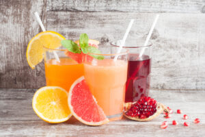 Glasses,Of,Pomegranate,,Grapefruit,,Orange,Juice,On,Wooden,Background.,Refreshments