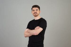 Portrait of young handsome man crossed his arms and looking at camera