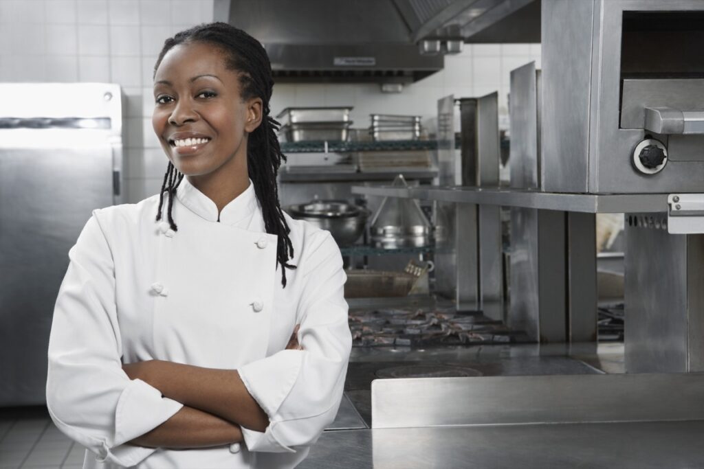 Portrait,Of,A,Smiling,Female,Chef,With,Hands,Crossed,In