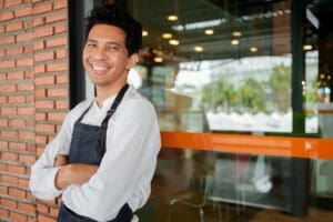 Young,Hispanic,Business,Owner,Smile,And,Hold,Tablet,For,Check