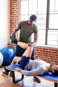 Trainer,Helping,His,Student,Stretch