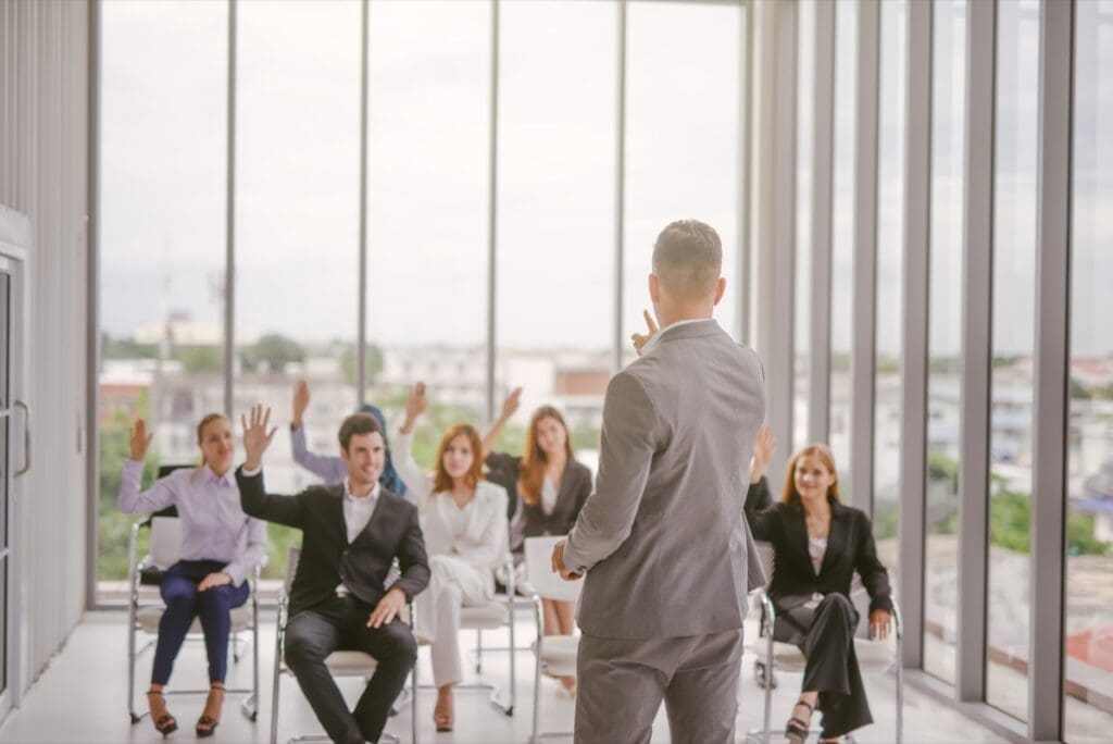 Businessman,Speaker,Giving,A,Talk,At,Business,Meeting.,Audience,In