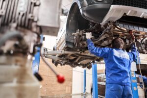 Car,Mechanic,Inspecting,Car,Steering,Rod,And,Repair,Suspension,Detail.